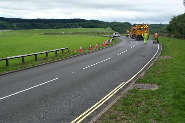 Yellow lines being painted near Carsington Water.
