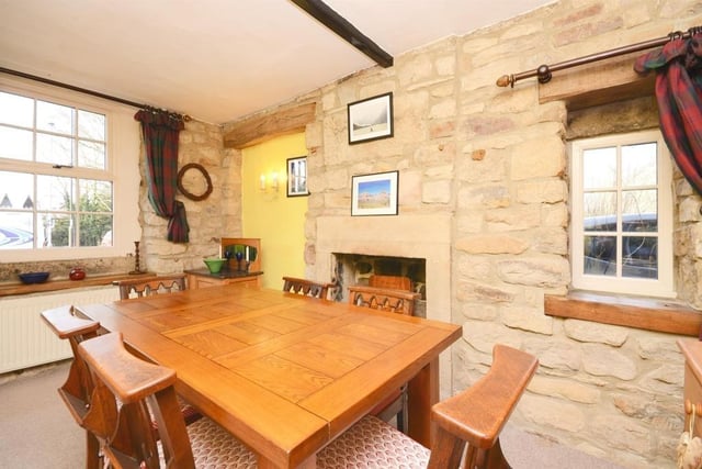 An eye-catching gritstone fireplace and hearth are inset into the feature stone wall.