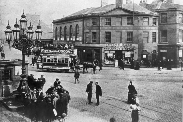 The Foot of Leith Walk was a busy place in 1898, with a horse-drawn tram taking people to and fro and customers flocking to George Marr's fruit and sweet shop with its window displays.