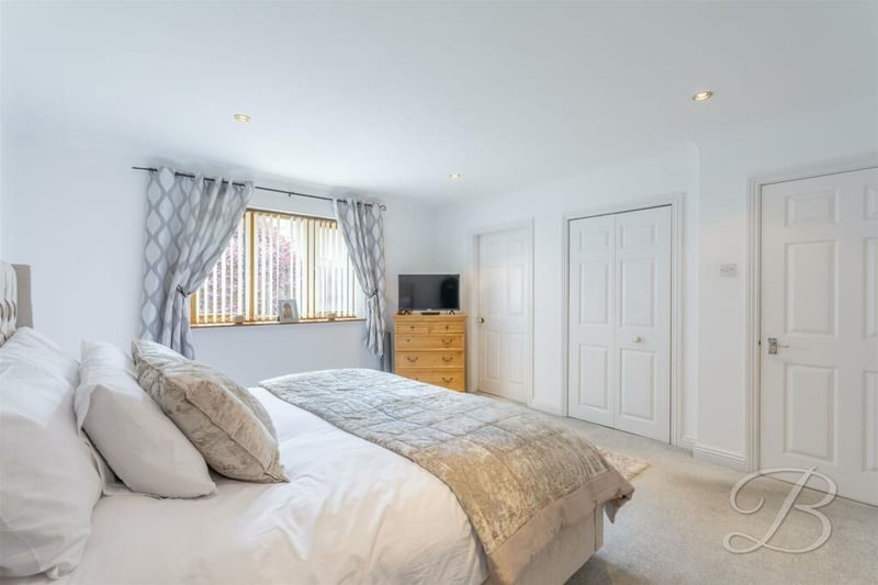 This bedroom has fitted carpets, a fitted wardrobe and access to an en suite.