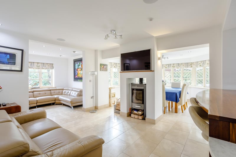 The open plan living area is a perfect family room and has a feature wood burner