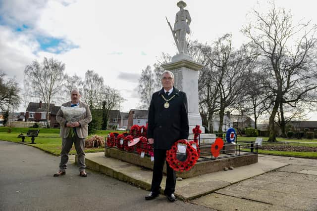 Laying a wreath for Captain Sir Tom Moore at Staveley Remembrance Gardens are Chair of Staveley Town Council Councillor Donald Parsons and Town Clerk Mark Evans.