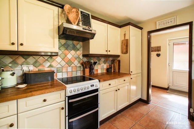 The living room/diner leads on to the kitchen at the back of the house. It is fitted with a range of base, wall and drawer units with work surfaces over. A free-standing cooker, with four-ring gas hob and extractor over, fits in well.