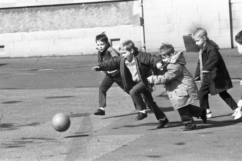 Little boys playing football in the playground of St John's RC primary school in Edinburgh, April 1989.