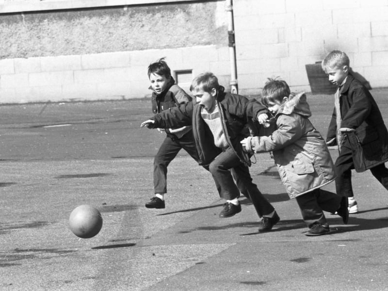 Little boys playing football in the playground of St John's RC primary school in Edinburgh, April 1989.