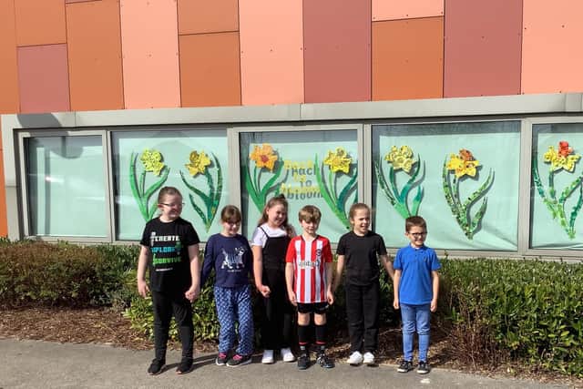 Year 4 children pictured with some of the daffodils which are on display at Sharley Park Community Primary School