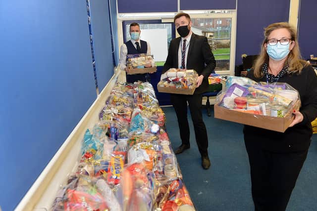 Parkside Community School has been distributing food parcels to help the needy. Pictured are Dawn Michell, early help officer, Aaron Millan, pastoral manager, and David Mills, deputy headteacher. Picture by Brian Eyre.