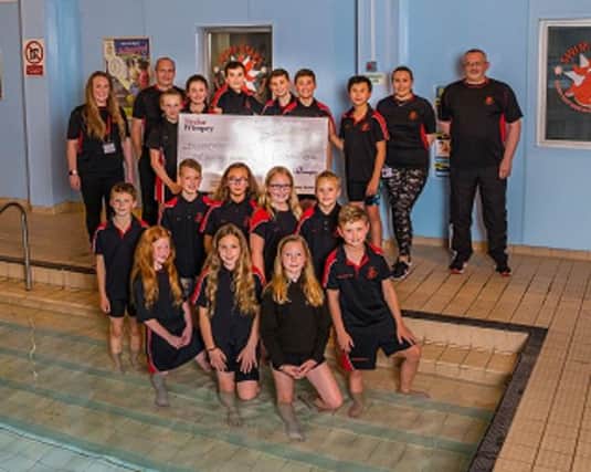 Rykneld Swimming Club with the donation from Taylor Wimpey.