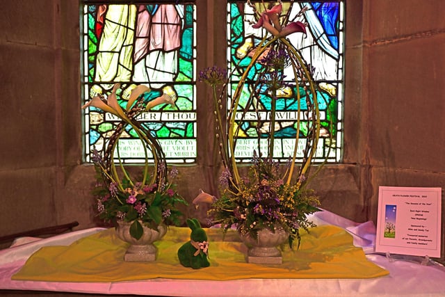 A backdrop of stained-glass windows for the flower festival.