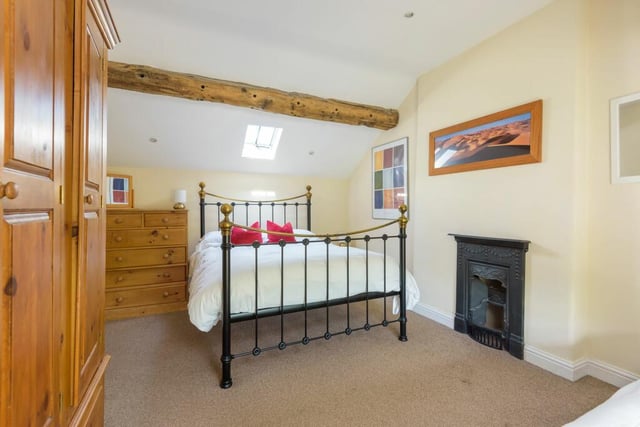 A cast iron fireplace is complemented in the style of the bedstead.