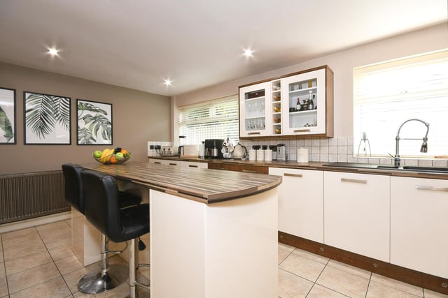The kitchen has integrated appliances, a range style cooker and central island.