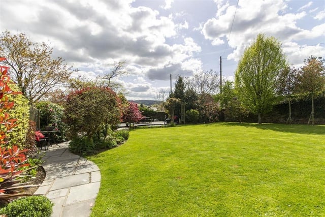 A large lawned area takes up much of the garden at the back of the property.