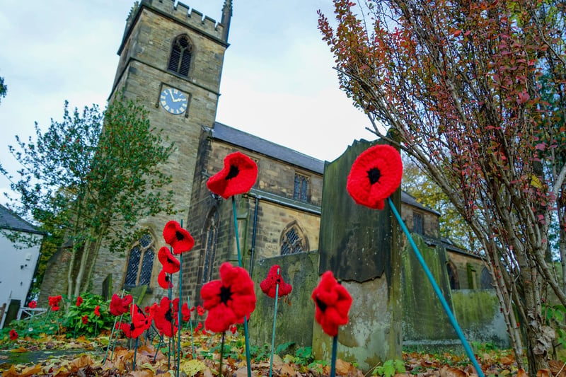 Knitted poppies decorate the grounds of Brimington church.