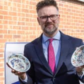 Charles Hanson with two of the four Chinese Ming Dynasty plates that sold for £63,000 at auction (photo: Hansons/Mark Laban)