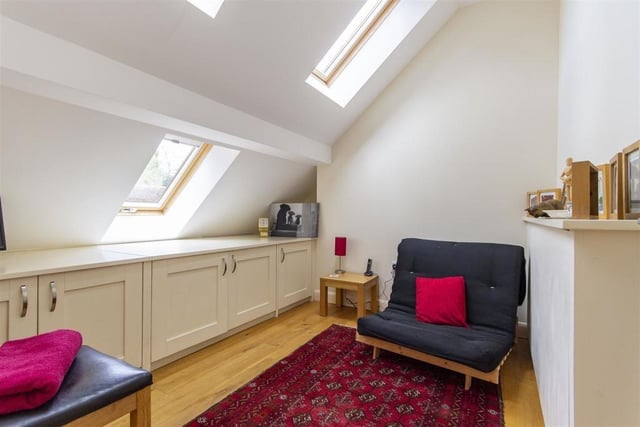Fitted base units and three skylight windows are features of this bedroom.