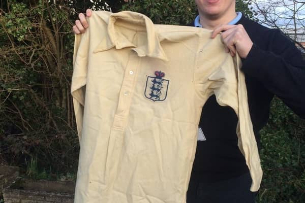 Sports valuer David Wilson-Turner with the England shirt from 1911 that sold for £4,000.
