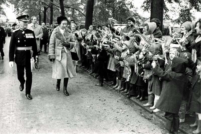 Princess Anne visits Bolsover Castle, October 1980, greeted by flag-waving children.