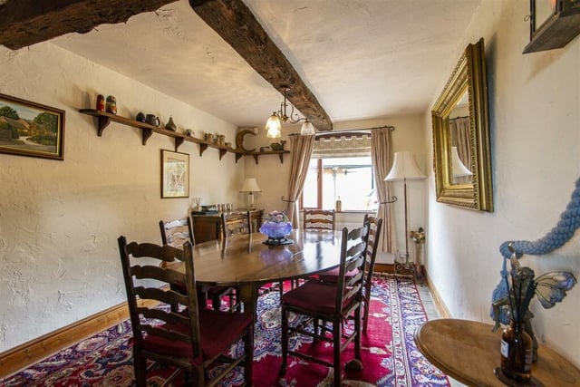 Original oak beams are a feature of the dining room.