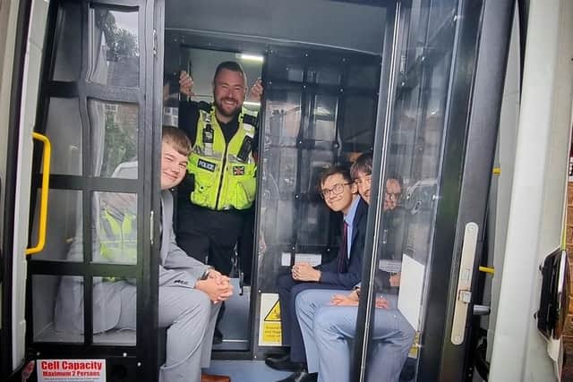 William with friends Fin and Charlie in the back of the police van