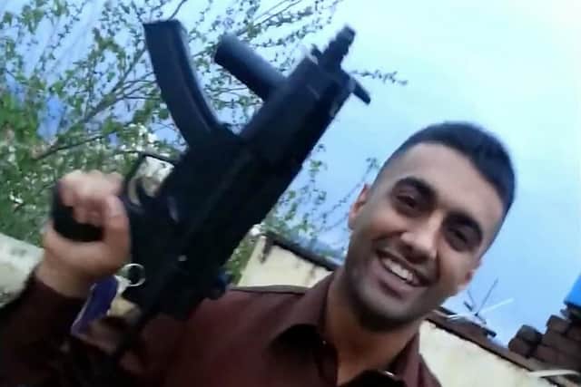 Tahir Zarif firing a machine gun in Pakistan in 2015.