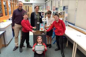 Headteacher Nick Newberry, Jacqueline De Veaux, with year 6 children Emily Greenwood (seated), Tristan Ferguson (left), Jack Carpenter and Oliver Mullis (right) celebrating winning the foodbank competition.