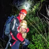 A Buxton Mountain Rescue Team member with the rescued dog.