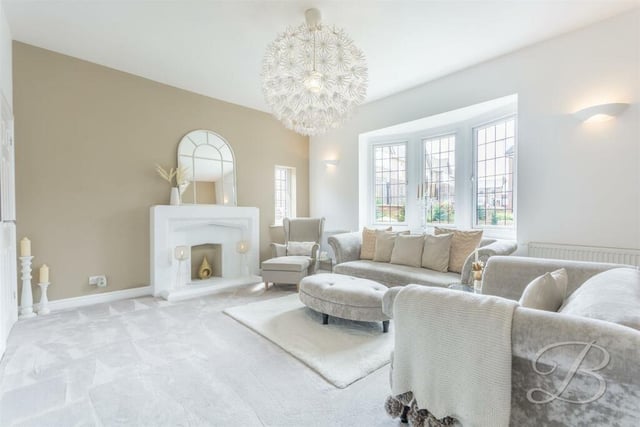 The first room to catch the eye on the ground floor of the West Hill Avenue house is this brilliant living room. It is distinguished by a large bay window facing the front of the property, and a feature fireplace.
