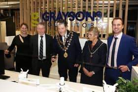 Councilllor Tony Rogers (middle), cuts the ribbon to officially open the new Graysons office with managing partner Peter Clark (second from left) and guests.