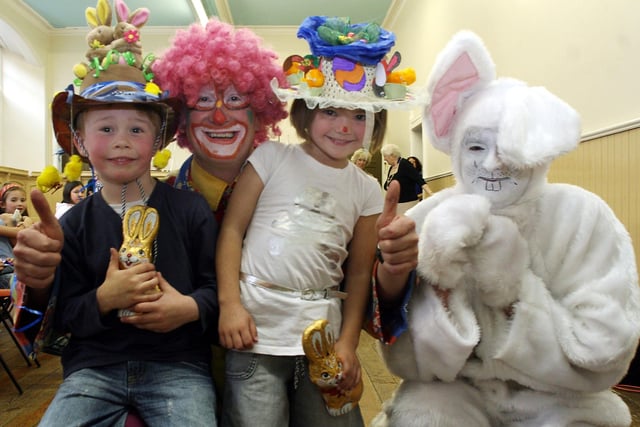 Easter bonnet competition winners Harry Ward, 5, and Abbie Piggot, 5, with Uncle Michael the clown and Easter bunny at a party hosted by the mayor of Bakewell.