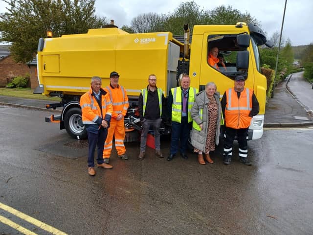 Pictured are Bolsover District Council and Scarab officials standing with the new street sweeper