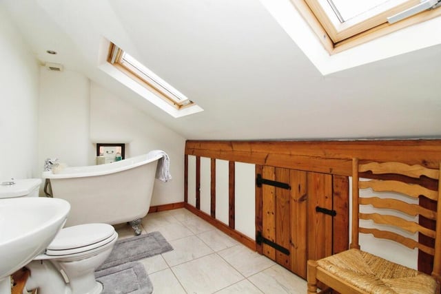 A roll-top, claw-foot tub with mixer tap is the highlight of the en suite bathroom to the second bedroom. It also features a pedestal wash hand basin, close-coupled WC and two Velux skylight windows.