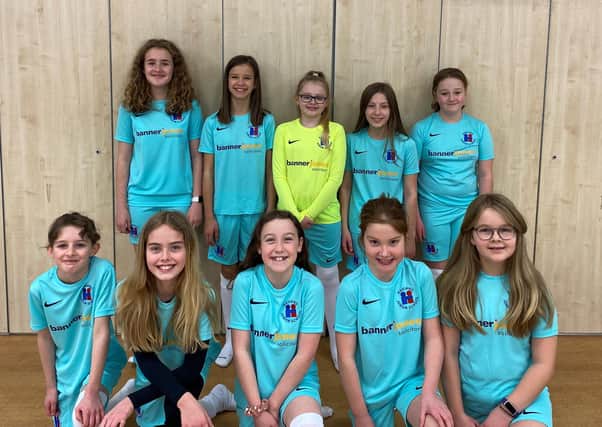 Hasland Junior School's girls team proudly show off their new kit.