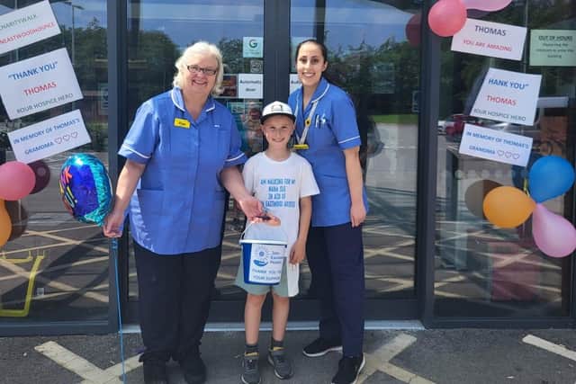 Thomas finished his walk at the John Eastwood Hospice in Sutton. He is pictured holding his collections bucket with hospice staff. Photo: submitted.