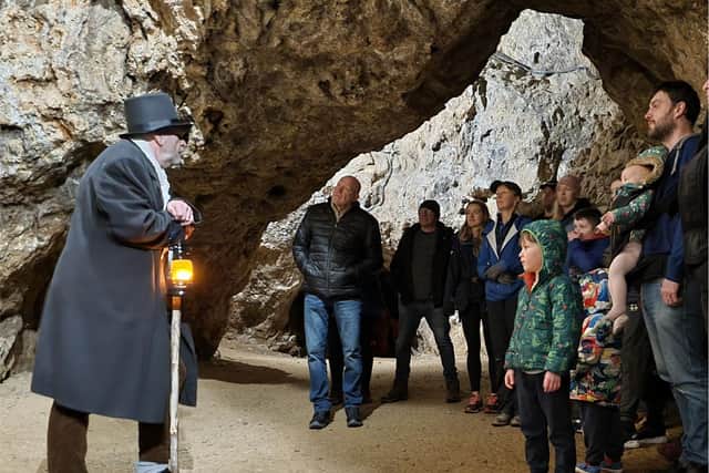 A guide in Victorian costume leads visitors aroundthe Great Rutland Cavern.