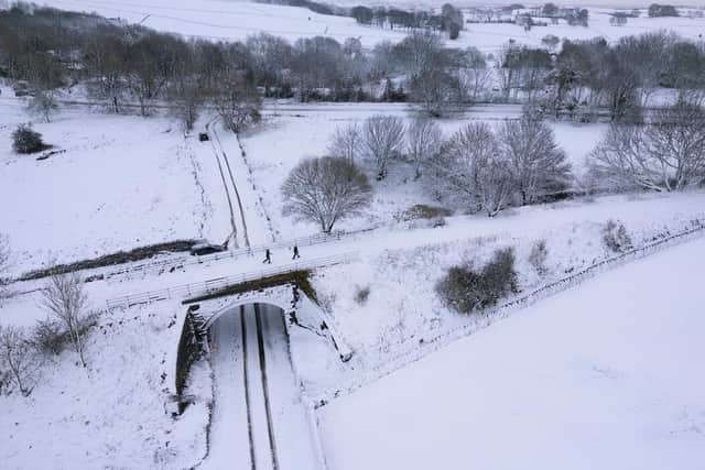 Wintry weather is set to return to Derbyshire as temperatures plummet again this week.  Walkers brave the cold on the Tissington Trail near Biggin after Heavy snow fall in the Peak District last weekend. Image: Rod Kirkpatrick/F Stop Press.