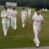 Ahmad Zazai leads the Chesterfield team off the field after his fine bowling performance.