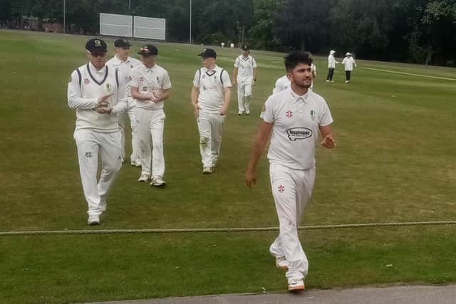 Ahmad Zazai leads the Chesterfield team off the field after his fine bowling performance.