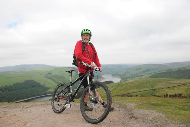 Rangers took to mountain bikes to patrol the Peak District National Park in 2013. Pennine Way ranger Martin Sharp at the top of Winstone Lee Tor overlooking Ladybower Reservoir.