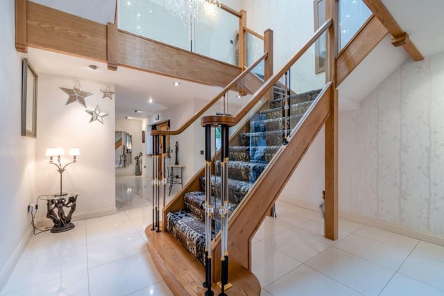 A well-lit staircase leads to the basement with spacious studio and games rooms.