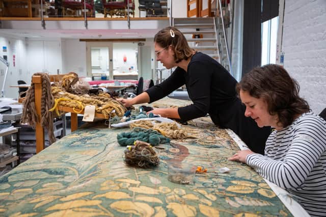 Conservators working on one of the Gideon tapestries at the Textile Conservation Studio, Norfolk.