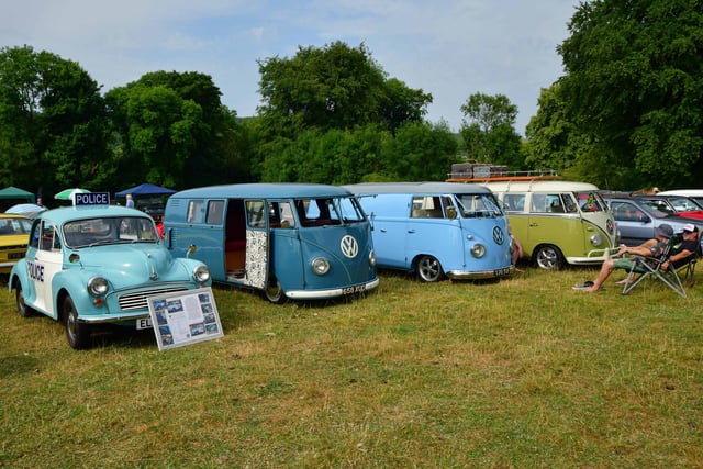 Volkswagen camper vans alongside an old Morris Minor police car.