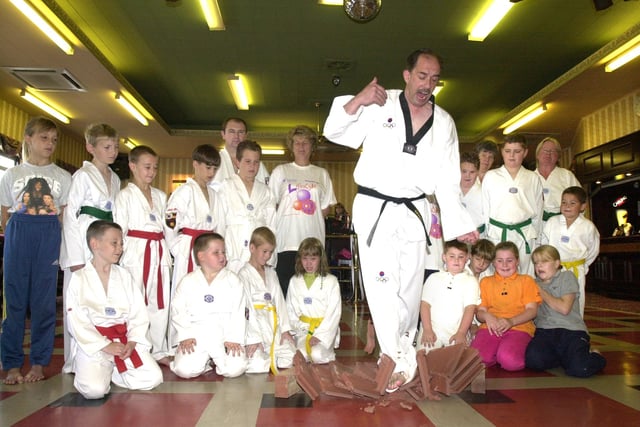 Youngsters watched Tai Kwondo expert Graham Ensor smash his way through roof tiles while practicing for a fundraiser at Thurnscoe W.M.C. in August 2000