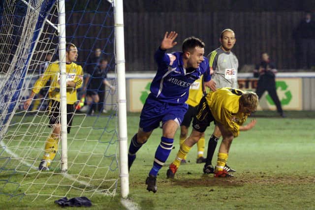 Matlock Town striker Ross Hannah turns away in delight after scoring against North Ferriby United.