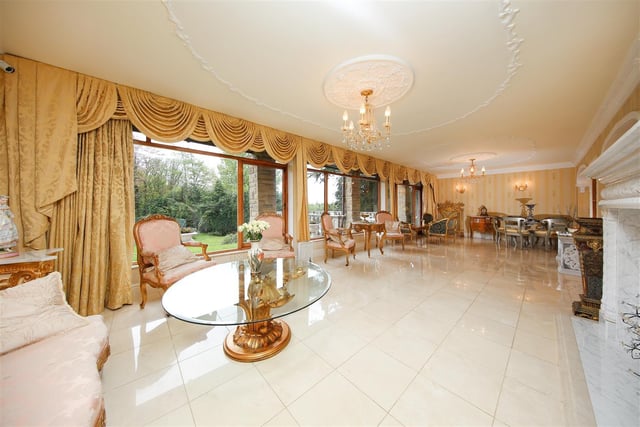 This luxuriously furnished room looks out onto the garden.