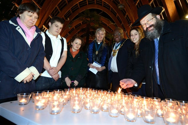 A Holocaust Memorial Day Candlelit Vgil took place at the Winter Garden, Sheffield in 2013. Our picture shows Rabbi Golomb (right), Lord Mayor of Sheffield, John Campbell (fifth left), Trevaen Anderson (second left), aged 15, who spoke at the event, and Lord Mayor's chaplain Reverend Louise Collins (fourth left), light candles at the vigil.