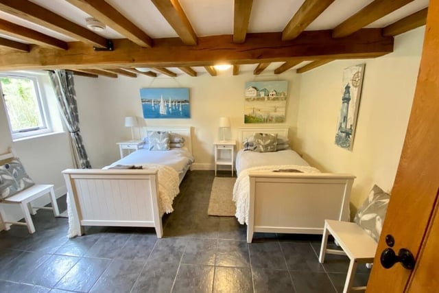 This good sized bedroom on the ground floor has exposed beams and overlooks the rear garden.