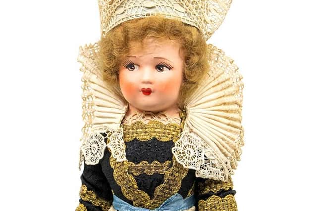 The 1930s Britanny doll is traditional costume.