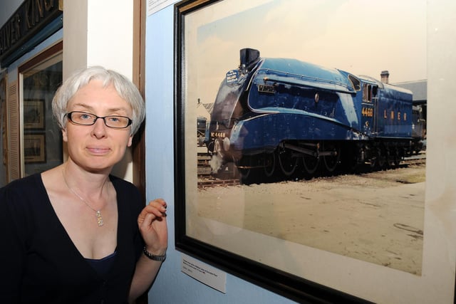 Museum manager Carolyn Dalton next to a painting of the Mallard in 1986 at the Mallard exhibition at Doncaster Museum