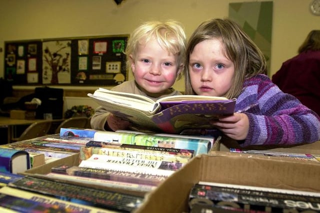 Brother and sister Asa and Ellie Jones ages three and six enjoying a book fayre in 2003.