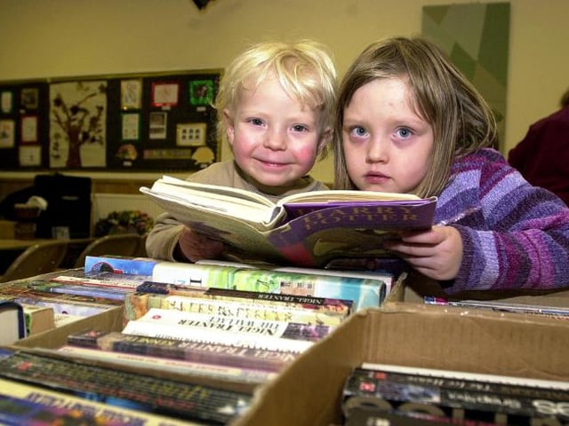Brother and sister Asa and Ellie Jones ages three and six enjoying a book fayre in 2003.
